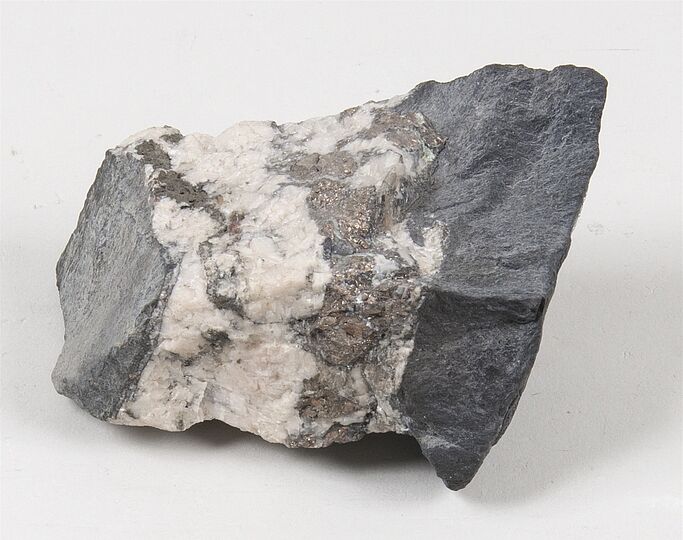 Erzprobe von Weißnickel mit weißen und metallisch glänzenden Adern.