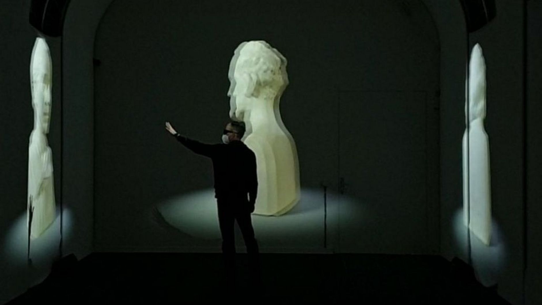 Mann mit VR-Brille greift nach 3D-Modellen