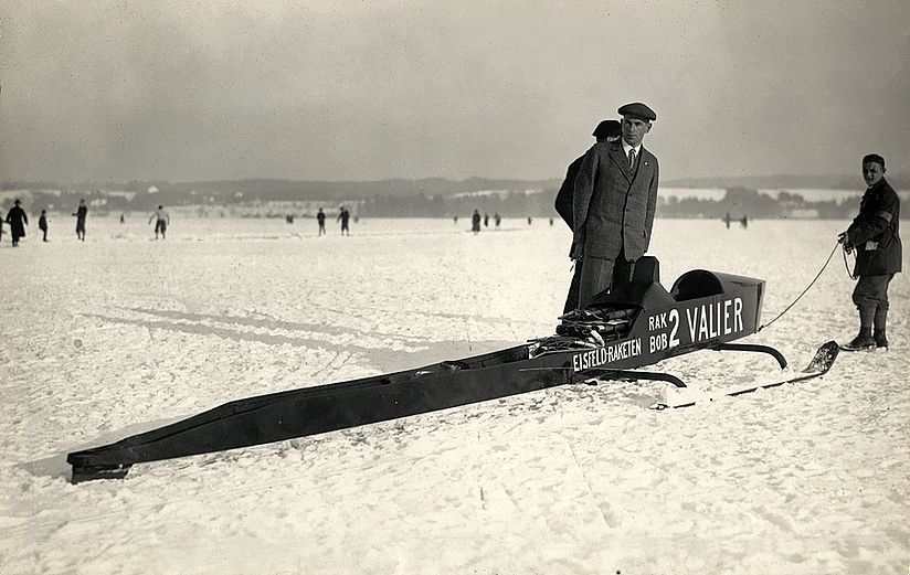 Alte Fotografie zeigt Max Valier neben seinem Raketenschlitten.