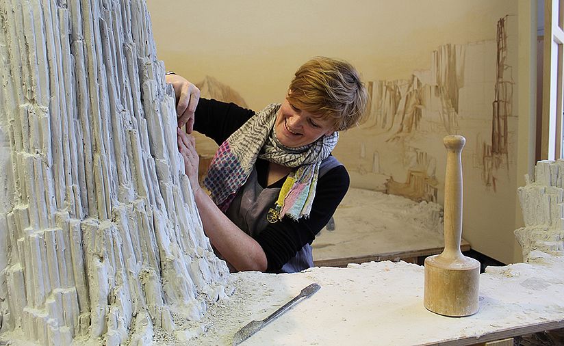 Bildhauerin Elisabeth Straßer bringt den Gips in Felsenform.
