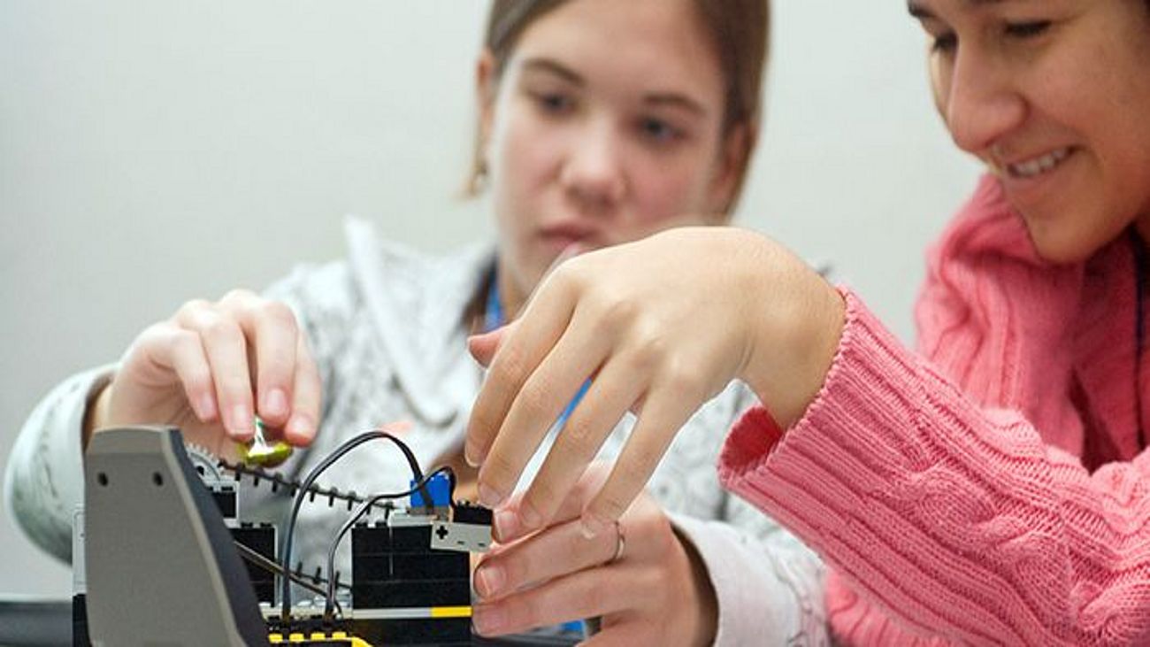 Mädchen experimentieren mit einem Roboter