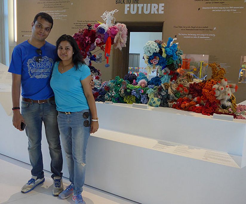 AB and his girlfriend in the Anthropocene exhibition in front of the Crochet Coral Reef.