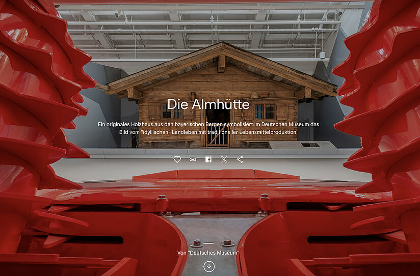 Almhütte in den Räumen der Landwirtschaftsausstellung des Deutschen Museums, frontal fotografiert. Introtext darüber sichtbar.